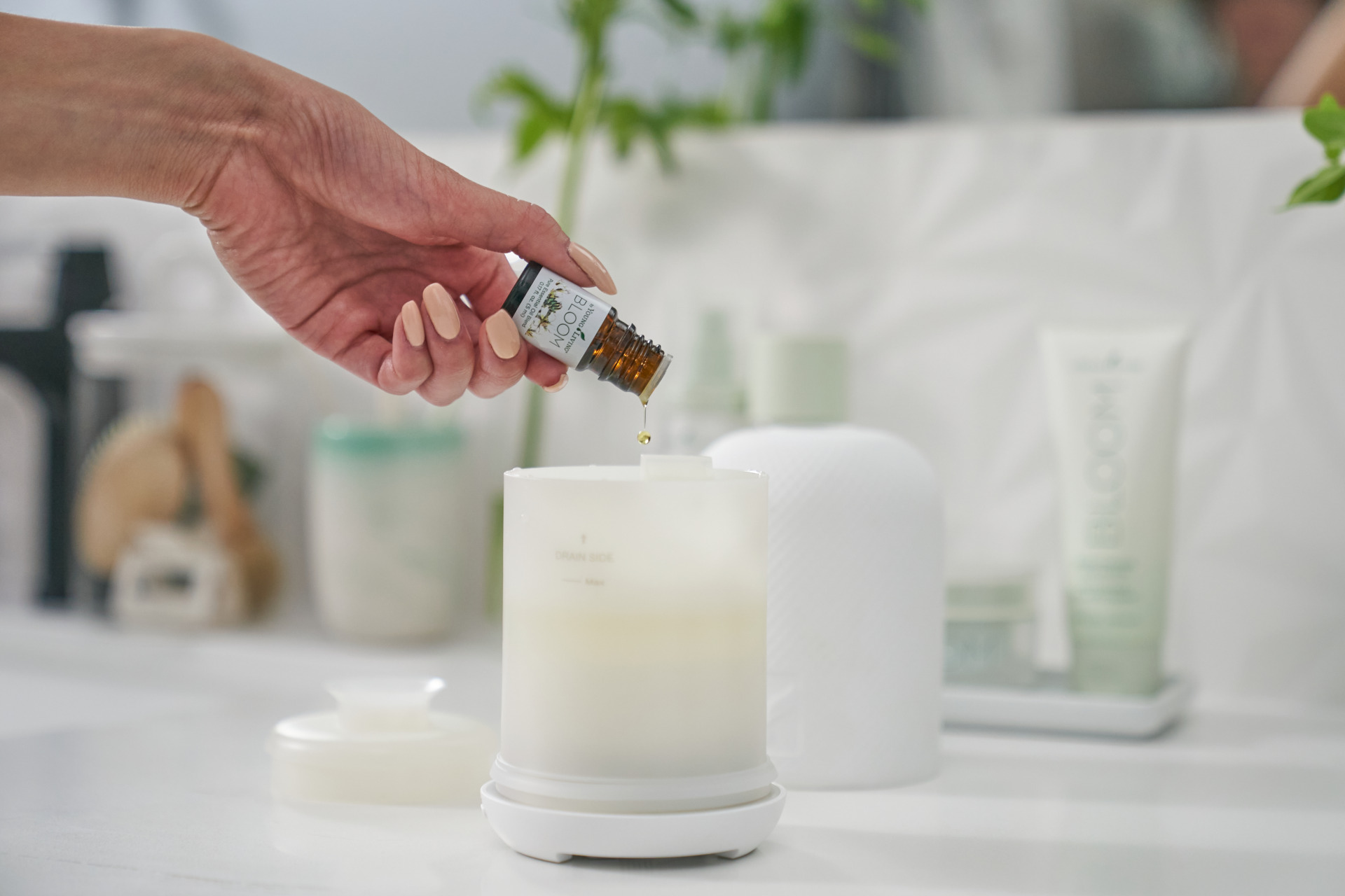 havenceramicdiffuser bloomessentialoil Woman adding essential oils to a diffuser